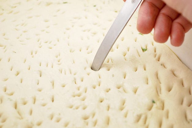 make tiny holes in the focaccia dough